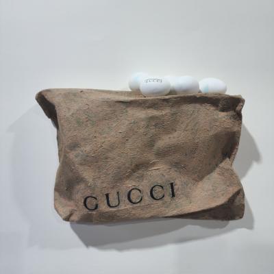 Gucci, 2025, used coal briquette, eggshell, thrown away items & mixed media, 42 x 32 x 10 cm