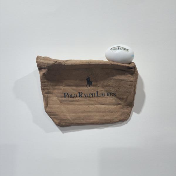 Polo, 2024, used coal briquette, eggshell, thrown away items & mixed media, 22 x 19 x 6,5 cm